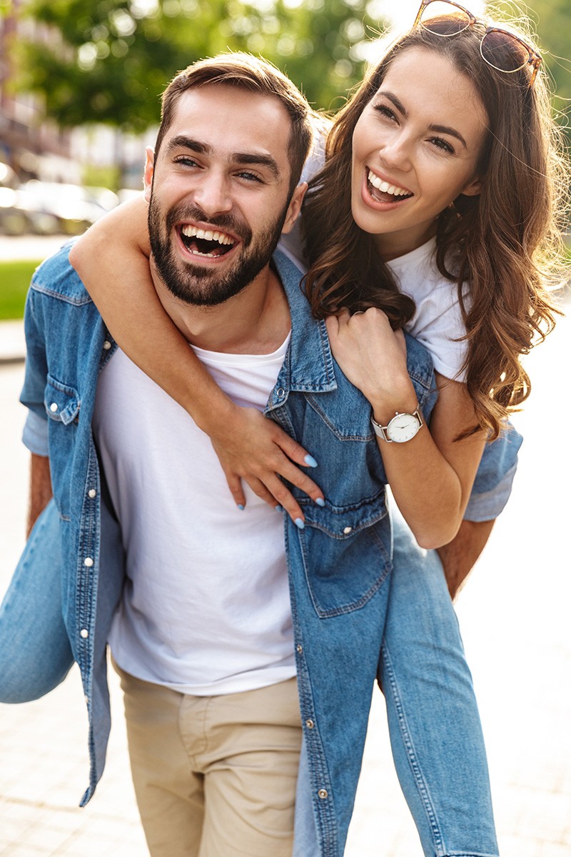 Happy Couple In Love Having Fun On Street. Beautiful Smiling Young Man And Woman Embracing, Laughing And Spending Time Together Outdoors. Romantic Relationships. High Resolution.