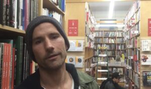 Dating coach standing in bookstore aisle in NYC
