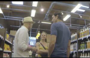 Man and woman smiling in a conversation with another shopper at Whole Foods NYC