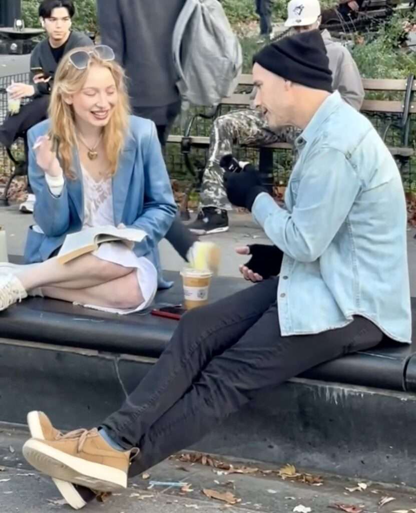 Dating coach John Keegan talking to a woman in Washington Square Park during a real-life coaching session in NYC