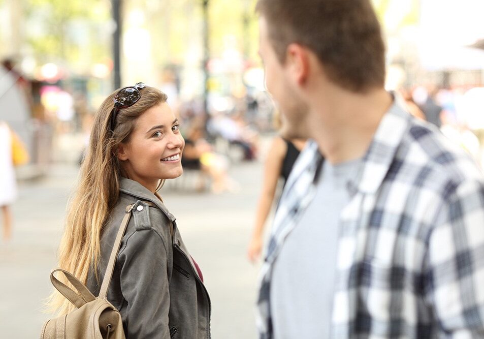 Strangers girl and guy flirting looking each other on the street